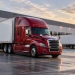 Red and white semi trucks at a logistics yard illustrating trucking working capital financing